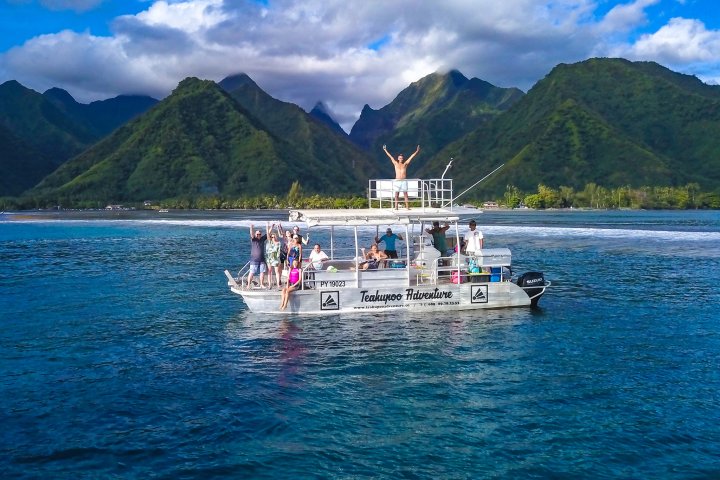 a small boat in a body of water with a mountain in the background