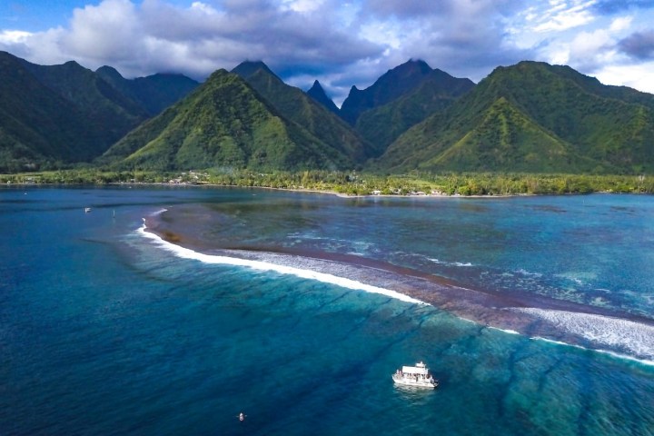 a body of water with a mountain in the background